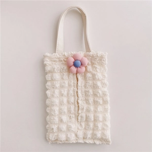 Detail of ivory bubble fabric car tissue box holder with blue floral 3D accents