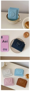 Detailed view of various macaron colors for the PU leather heart-embossed short wallet