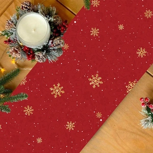 Christmas table runner with golden snowflakes on red fabric, festive decor with pine cones