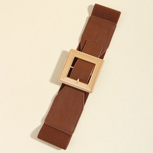 Detail shot of a brown elastic waist belt with a textured gold square buckle