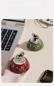 Mechanical magnetic kitchen timer with retro dial and clear scale in modern home office setup