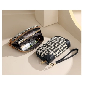 Detail of houndstock clutch bag with interior storage for lipstick and phone