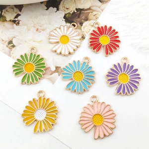 Flat lay of colorful daisy enamel charms in seven vibrant shades for DIY jewelry making