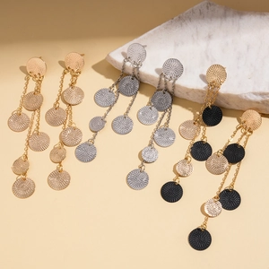 Chic metallic round textured tassel long drop earrings in gold and silver on marble