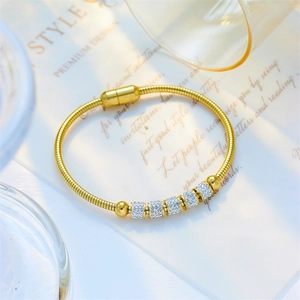 Golden snake chain bracelet with sparkling crystal spacers and magnetic clasp