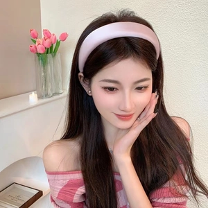Elegant pink satin padded headband for women with high-top sponge design in soft home setting
