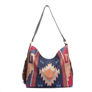 Close-up of bohemian woven tote bag with geometric patterns and brown tassel details