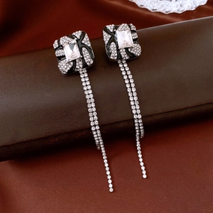 Detail of square vintage fringe earrings with black enamel and sparkling diamonds