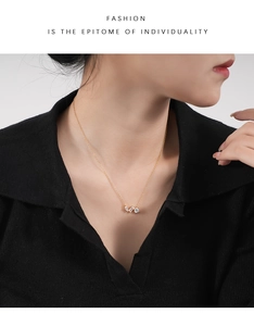 Detail of 925 sterling silver gold necklace with three clear zircon stones on neck