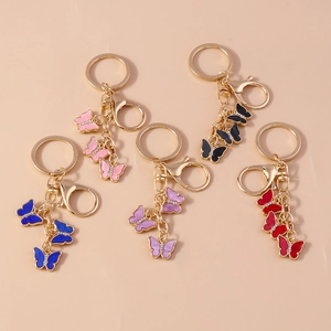 Close-up of five colorful butterfly keychains with rhinestones and enamel details