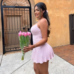 Close-up of pink slim-fit sundress with V-neckline and elegant tulip floral props