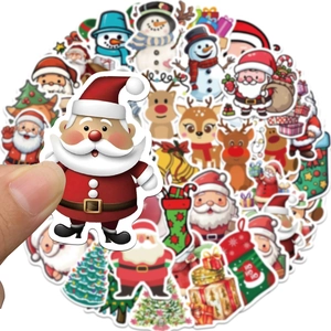 Close-up of hand holding a cartoon Santa sticker from a large holiday decoration set