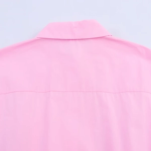 Detail view of the pink poplin dress back yoke and clean stitching on woven fabric