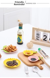 Macro view of sunflower and leaf shaped ceramic sauce dishes with smooth glazed finish