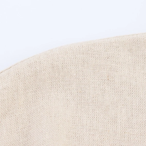 Detailed close-up showing the coarse weave texture of beige faux linen fabric material