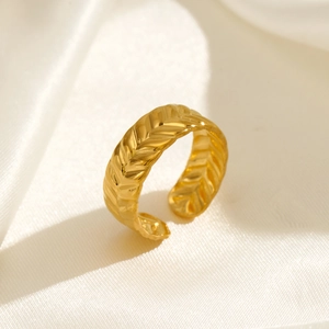 Gold adjustable wheat spike ring in stainless steel displayed on silk fabric background