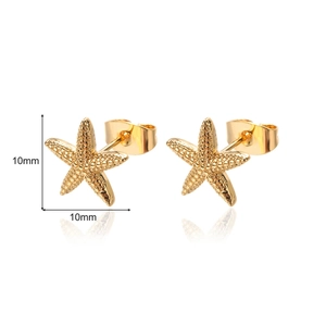 Macro detail of 10mm gold starfish stud earrings showing precise size and metallic texture