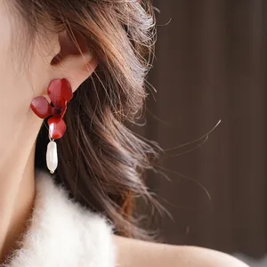French vintage red flower earrings with irregular pearl drop shown on model profile