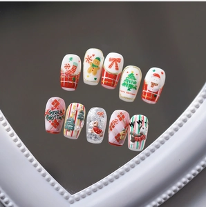 Detailed view of Christmas nail stickers with festive patterns and reflective mirror effect