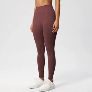 Macro shot of high waist seamless yoga leggings in deep red with moisture-wicking fabric