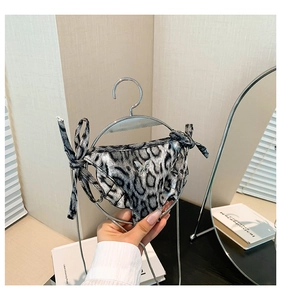 Detail of leopard print bikini style mini bag with silver butterfly and metallic finish