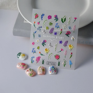 Close-up of 5D embossed nail art stickers featuring delicate 3D floral designs