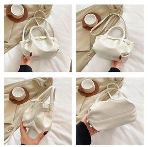 Detailed views of creamy beige pleated handbag showing texture and gold clasp hardware