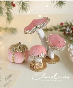 Detailed view of burgundy velvet mushrooms and pumpkin with gold glitter for Christmas decor