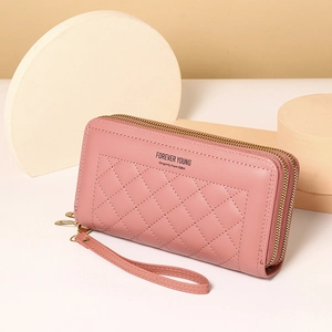 Close-up of pink quilted PU leather wallet with dual zippers and a detachable wrist strap