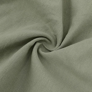 Detailed macro view of the breathable sage green linen fabric texture on men's summer shorts