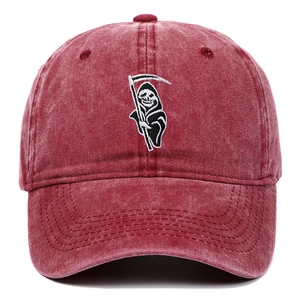 Macro detail of Grim Reaper embroidery on vintage washed burgundy cotton baseball cap