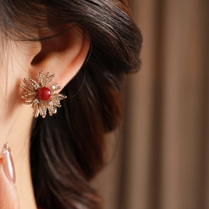 Macro detail of firework resin stud earring with red center stone and zircon accents