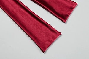 Detailed close-up of wine red satin stretch fabric with elegant silky reflective texture