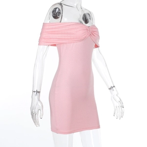 Close-up of pink off-the-shoulder mini dress with sparkling sequin details and texture