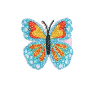 Close-up of butterfly hair clip with colorful sequins and pink ribbon duckbill clamp