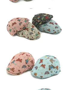 Detailed flat lay of ethnic beret hats featuring colorful butterfly embroidery patterns