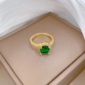 Elegant gold plated halo ring featuring a round green zircon stone and micro-pave setting
