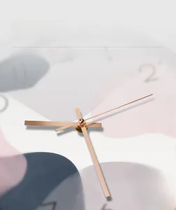 Detailed view of champagne gold metal hands on a modern minimalist wall clock face