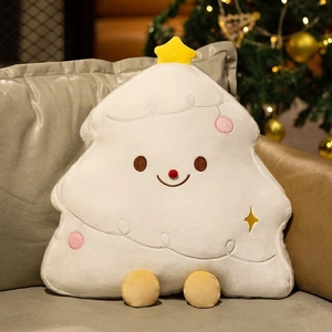 Detailed view of a white plush Christmas tree pillow with star topper and pink ornaments