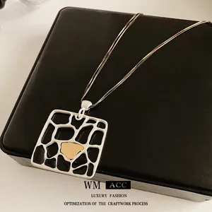 Double-layer silver chain necklace featuring a matte geometric square cutout pendant