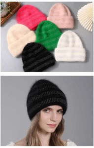 Close-up of soft rabbit fur knit beanies in various colors for winter warmth