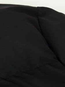 Macro shot showing high-quality quilted stitching and black synthetic fabric texture