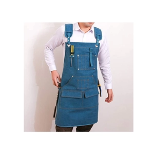 Detail view of durable blue denim apron featuring reinforced pockets and adjustable straps