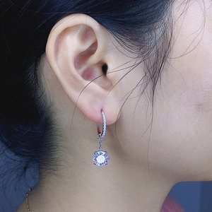 Silver drop earrings with round cubic zirconia stud and tassel chain on female model