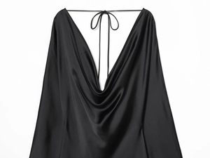 Detailed view of the elegant draped cowl neck on this black satin silk slip dress