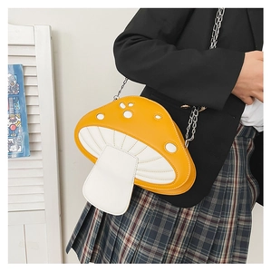 Detail of yellow mushroom crossbody bag with silver chain worn by a model