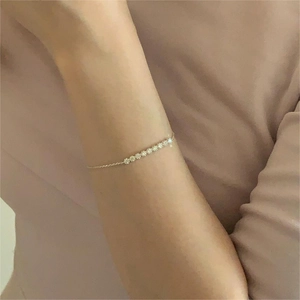 Close-up of minimalist S925 silver bracelet with sparkling pavé zircons in rose gold finish
