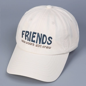 Close-up of FRIENDS embroidery detail on off-white cotton baseball cap in 45-degree view