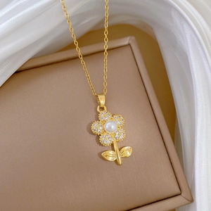 Detail of flower necklace with white pearl and pave crystals on silk background