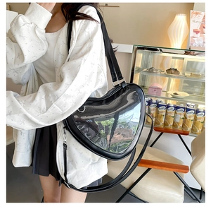 Detail of heart-shaped transparent window on black JK uniform crossbody ita bag
